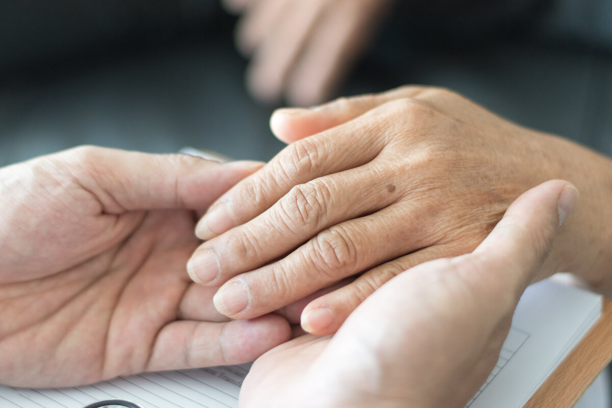 Holding hands between caregiver and seniors