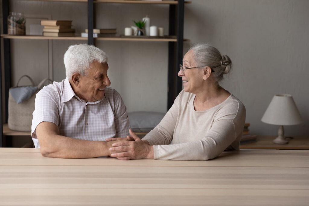 Happy couple with dementia smiling at each other