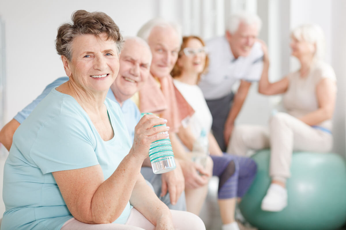 Group of older adults drinking water for senior summer safety