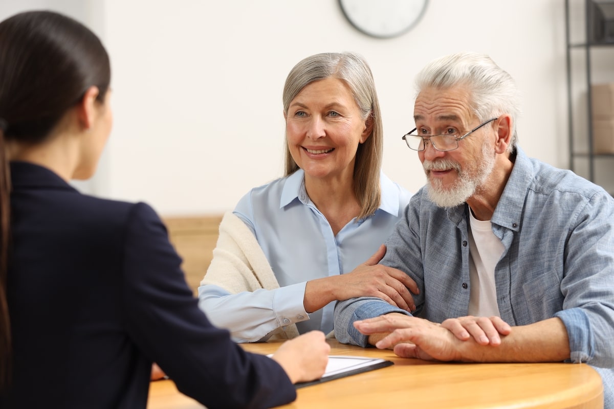 Older couple taking advice from a memory care representative