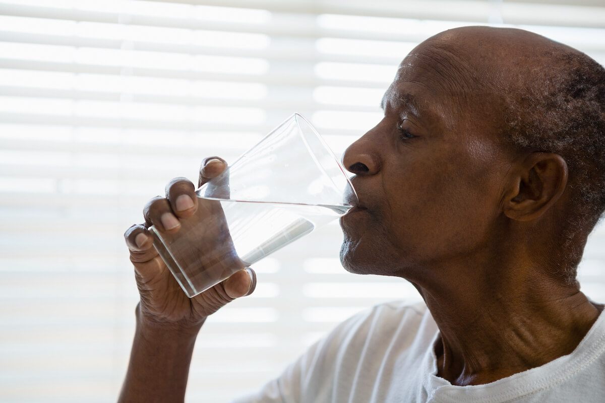Older man drinking water