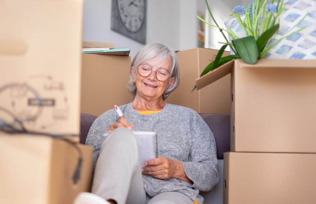 Older adult with moving boxes for downsizing