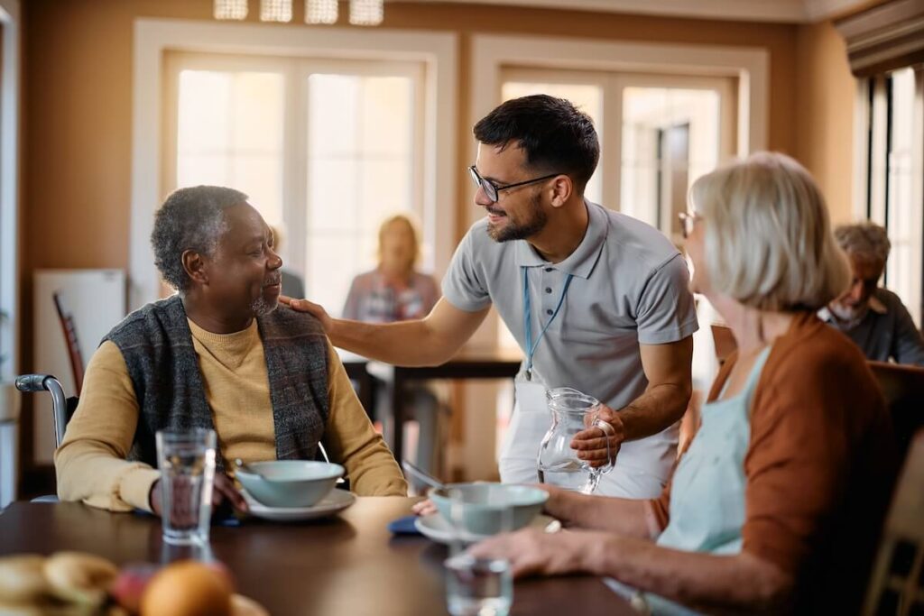Older adults sharing a meal in a senior living community