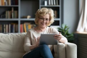 Smiling older woman using her iPad