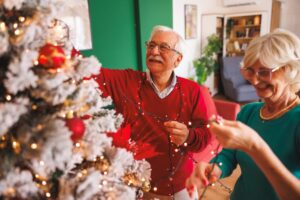 Older adult decorating their Christmas tree