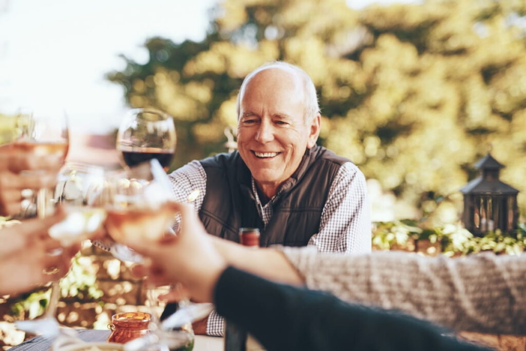 senior enjoys drinks and a meal