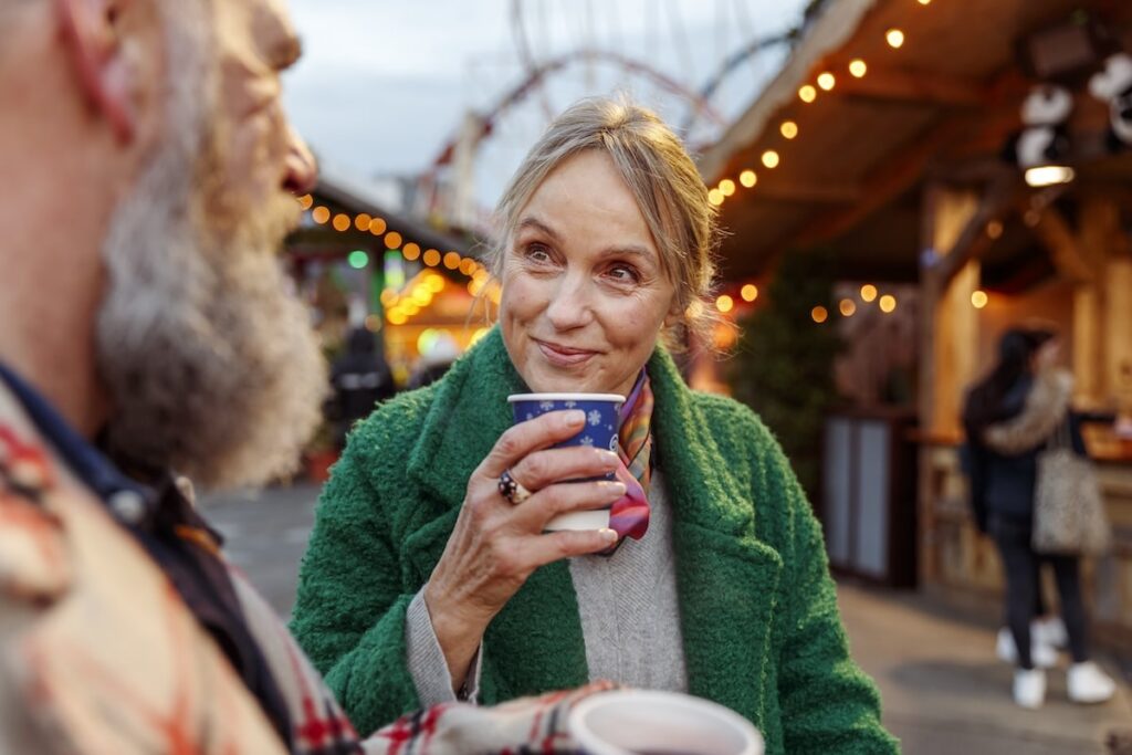 Senior enjoys warm drink at fall festival